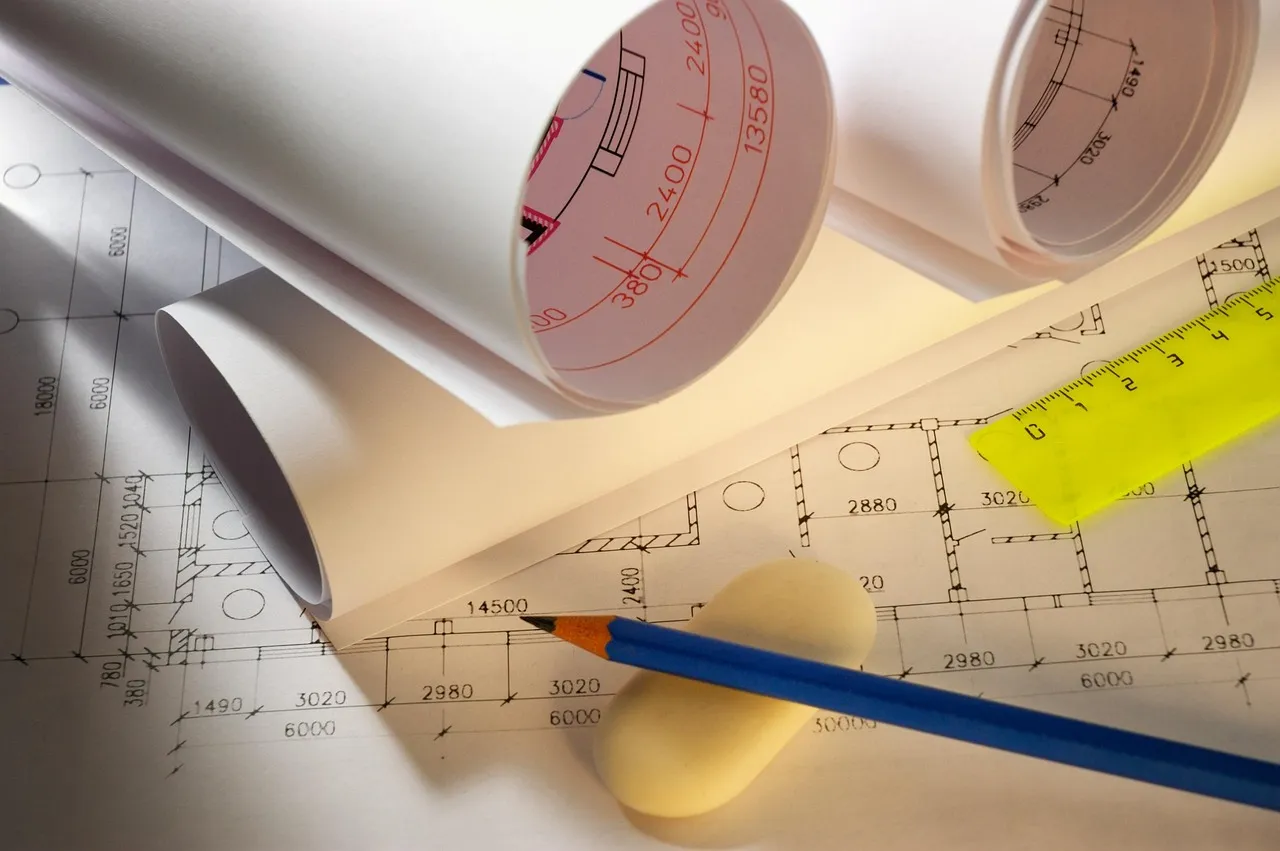 Architectural blueprints with pencil, ruler, and eraser. As-built documentation.