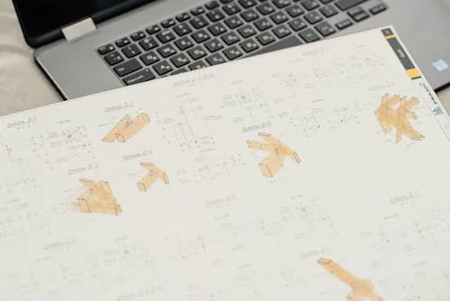 4D BIM construction sequence blueprint with a laptop.