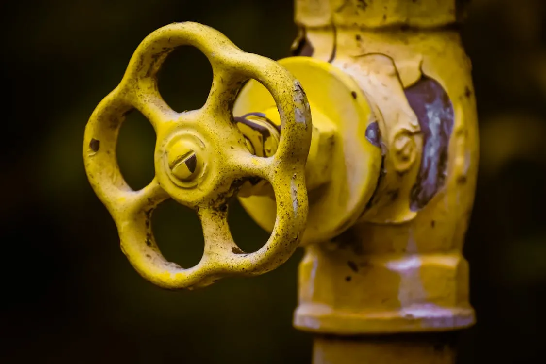 Yellow gas valve on a pipe with chipped paint, suitable for CCSM MEP BIM content.